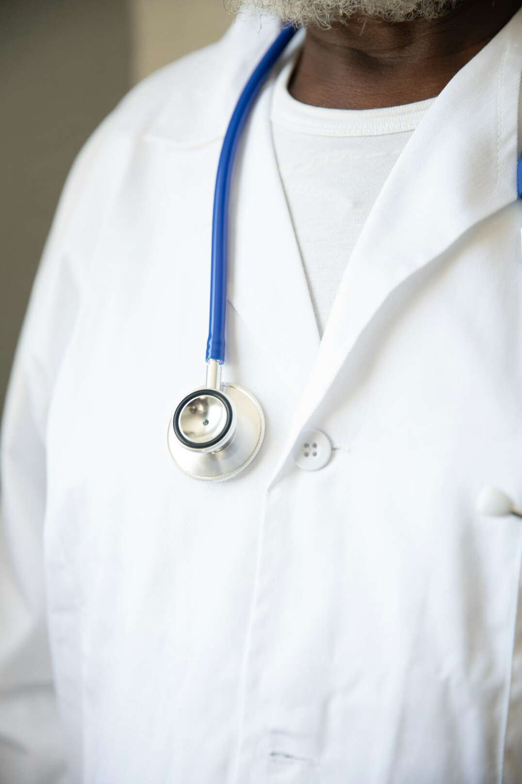 Male health professional in white coat portrait
